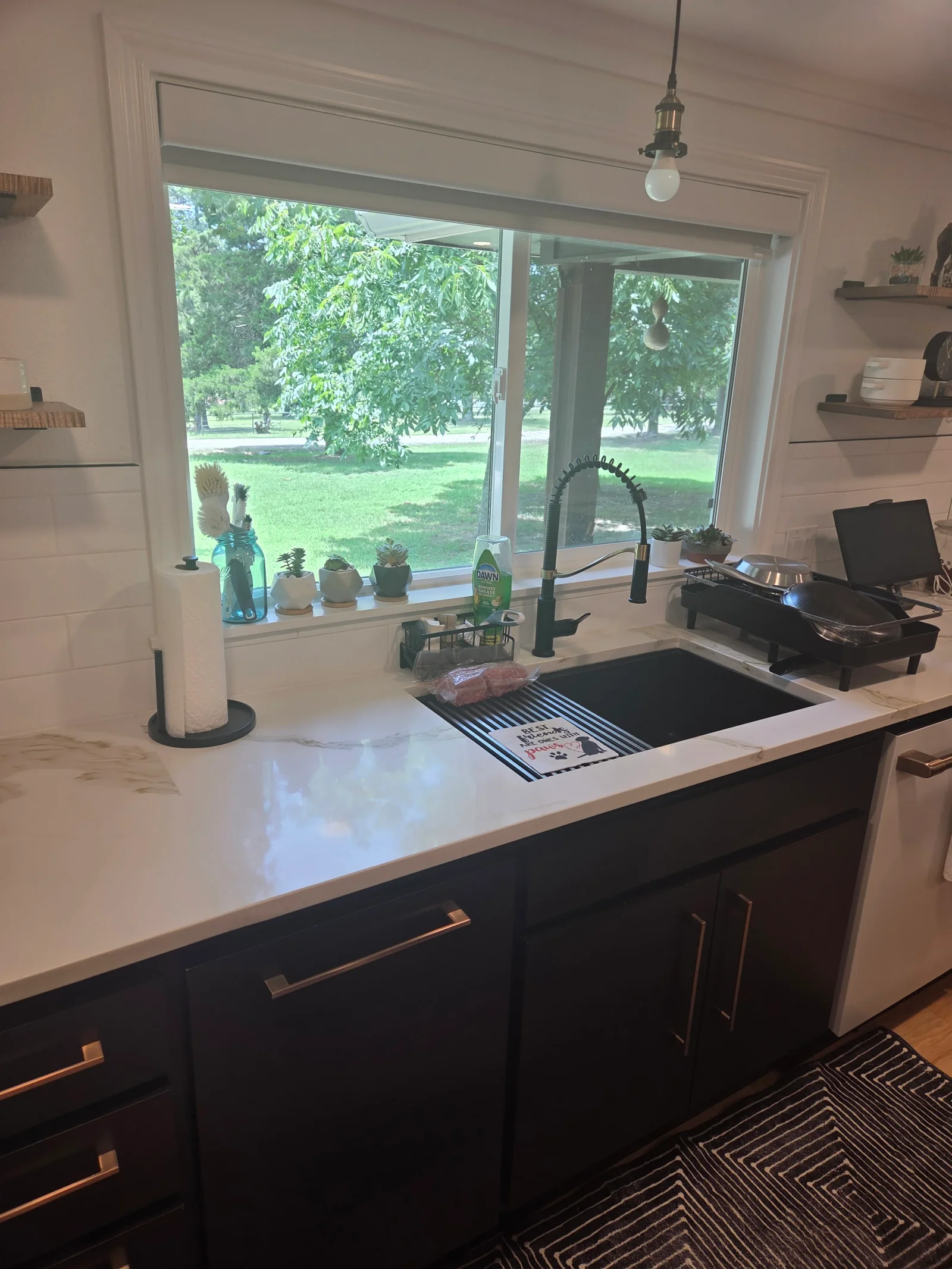Black and white kitchen island with quartz countertop, undermount sink, and gooseneck faucet